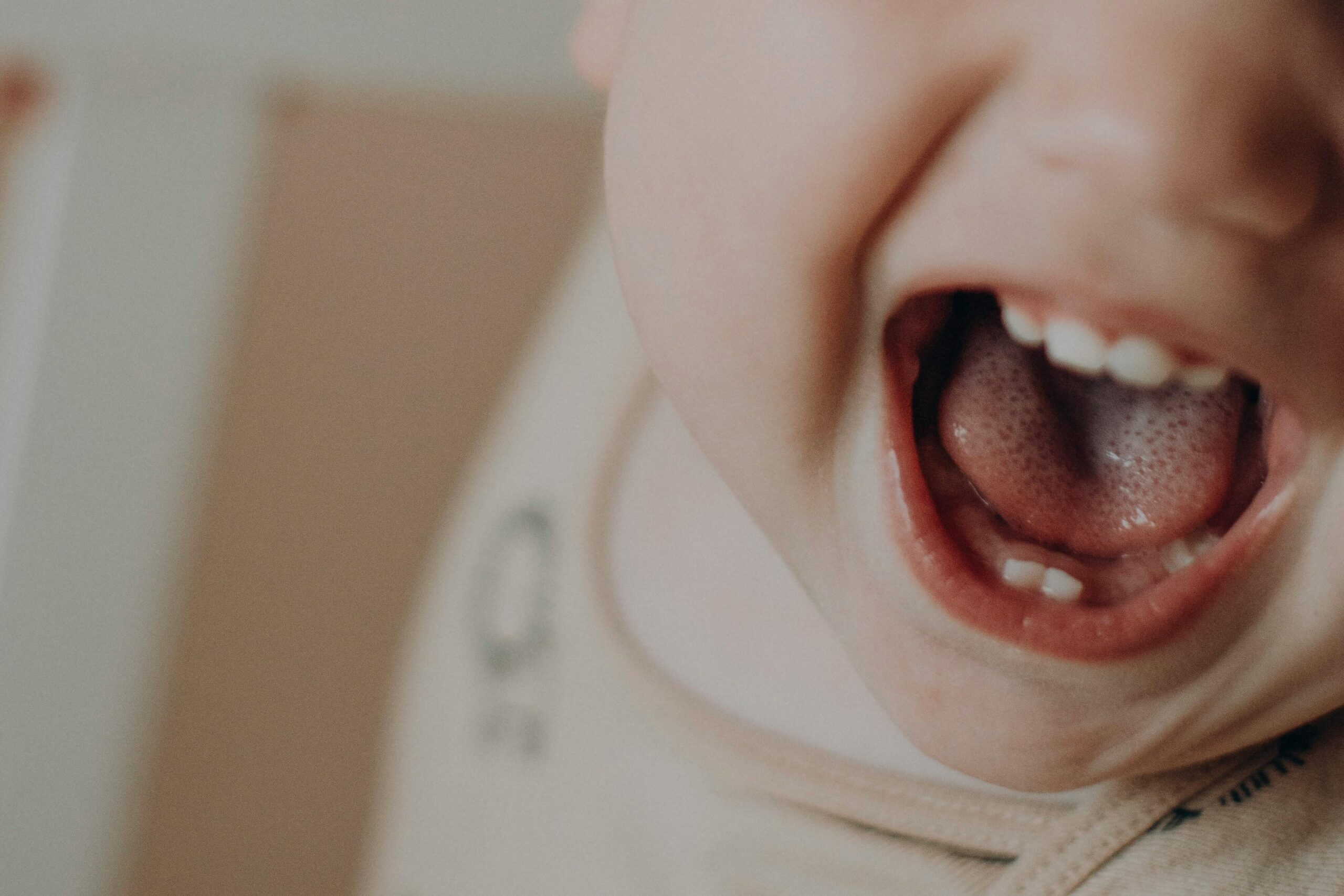Adorable baby smiling widely in a heartwarming close-up shot.